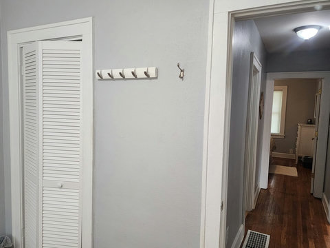 Closet that holds cabinet with drawers to hold your stuff and extra towels. Plus hooks for clothes that maybe you dont feel like putting up.