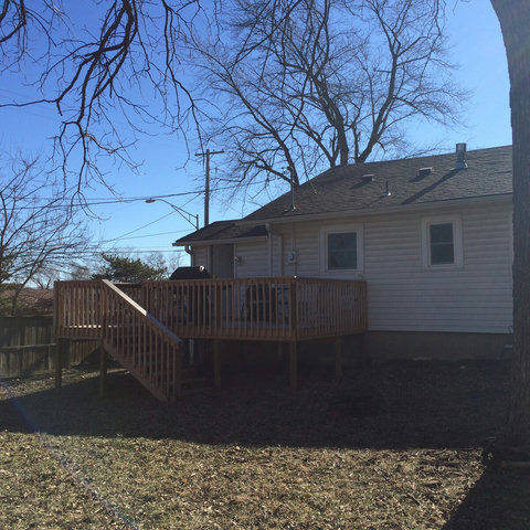 View of large deck from the large fenced in back yard.