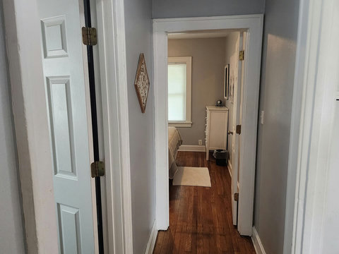 Picture of hallway going into back queen bedroom and door on the left goes into bathroom.