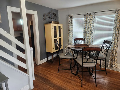 Different view of dining seating area-stairs going up to loft/office and also doorway to kitchen