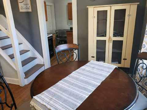 Close up of stairs leading up to office and entrance to kitchen.