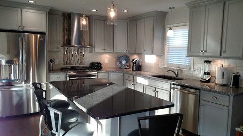 Close up picture of beautiful kitchen with granite counter tops and GE Profile appliances. Stove is gas.
