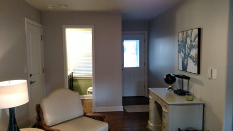View of half bath and doors leading to garage and screened in porch