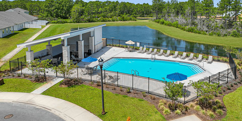 Resort-style pool with pavilion and lounge chairs