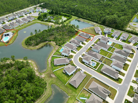 Aerial view of home and community pool