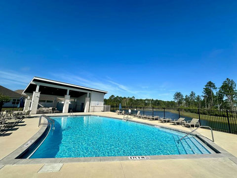 Sparkling community pool with lounge chairs