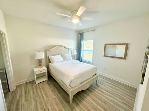 Airy bedroom with weathered wood headboard