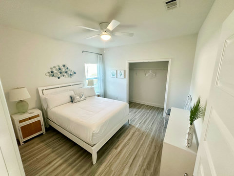 Bright bedroom with starfish pillow and closet