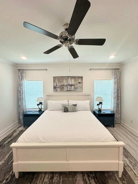 Nautical bedroom with sailboat canvas and palms