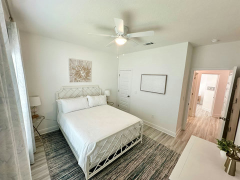 Bamboo-style bed on striped coastal rug
