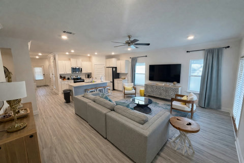 Open-concept living room with sectional and TV