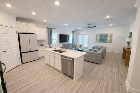 Spacious living room and modern white kitchen