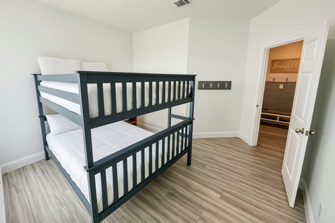 Navy bunk beds with crisp white linens