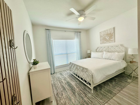 Lattice-frame bed with teal striped rug