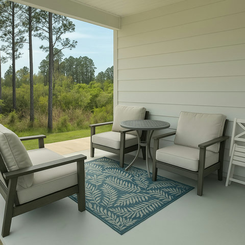 Shaded patio seating overlooking green lawn