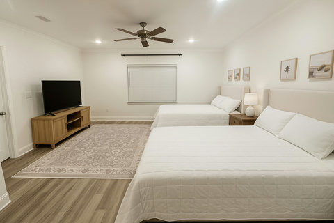 Two queen beds with TV and beach art