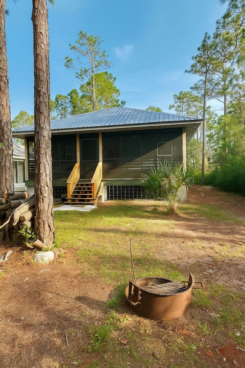 Screened cottage porch with outdoor fire pit