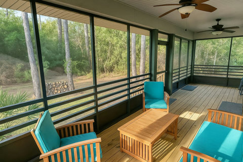 Screened porch with teal cushions and woodland views