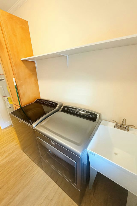 Full laundry setup with utility sink