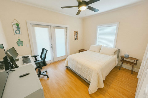 Bright bedroom with dual-monitor work desk