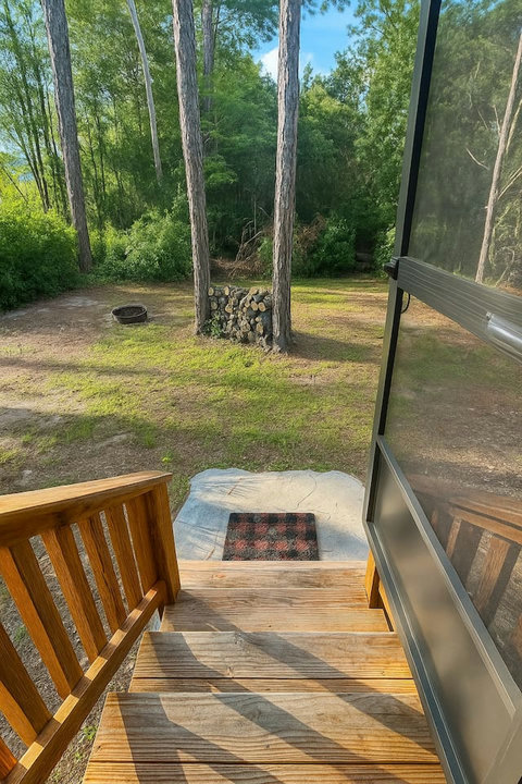 Backyard fire pit and firewood among the trees