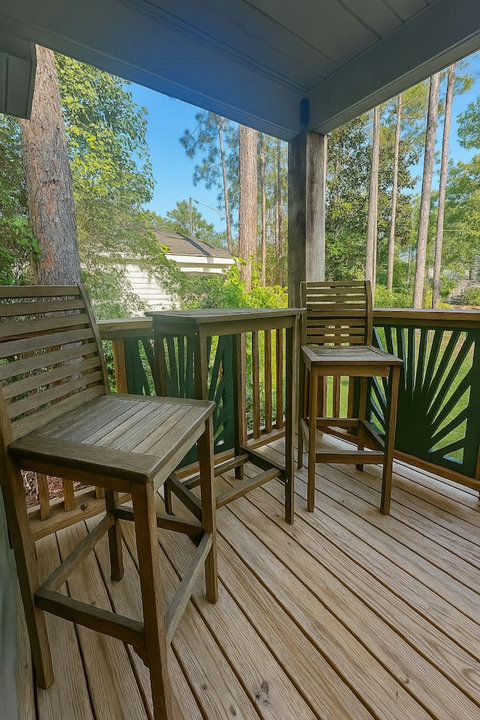 High-top porch seating among the tall pines