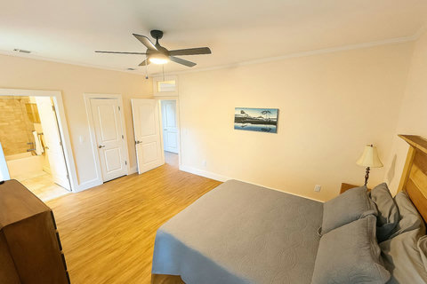 Airy bedroom with ensuite bath just beyond