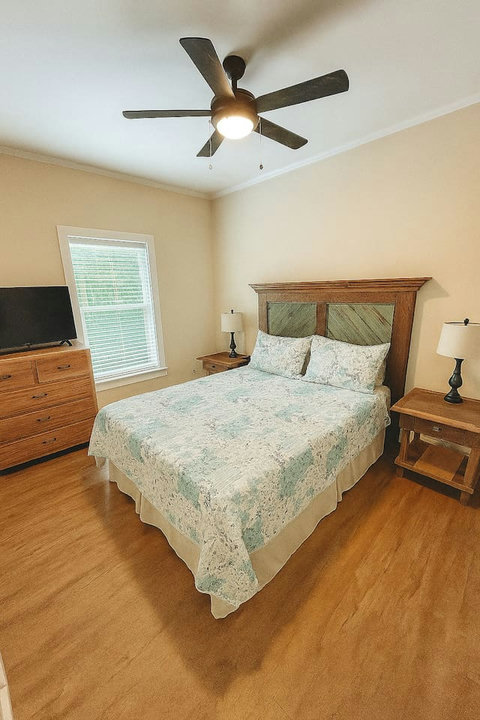 Cozy bedroom with floral quilt and wood headboard