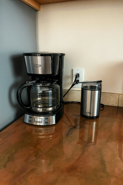 Coffee maker and grinder ready on the counter