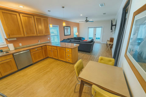 Open living area with navy sectional and kitchen