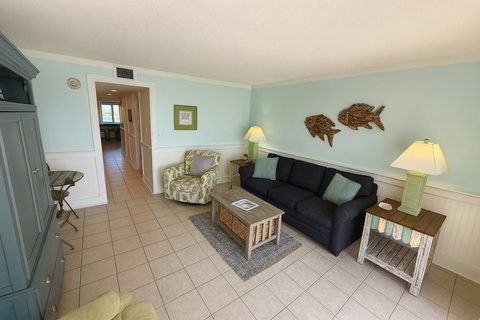Navy sofa under driftwood fish wall art