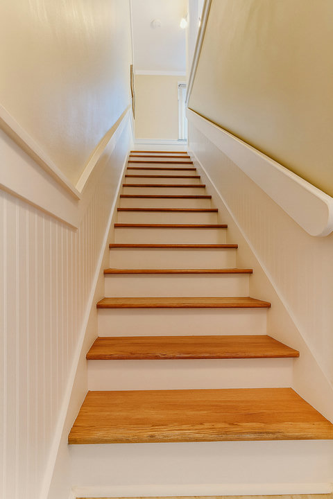 Wood staircase with classic coastal trim