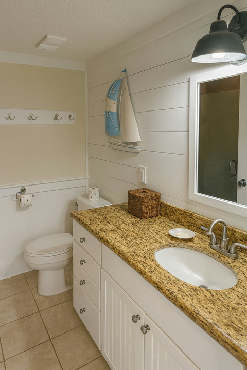 Granite vanity bath with sailboat wall accent