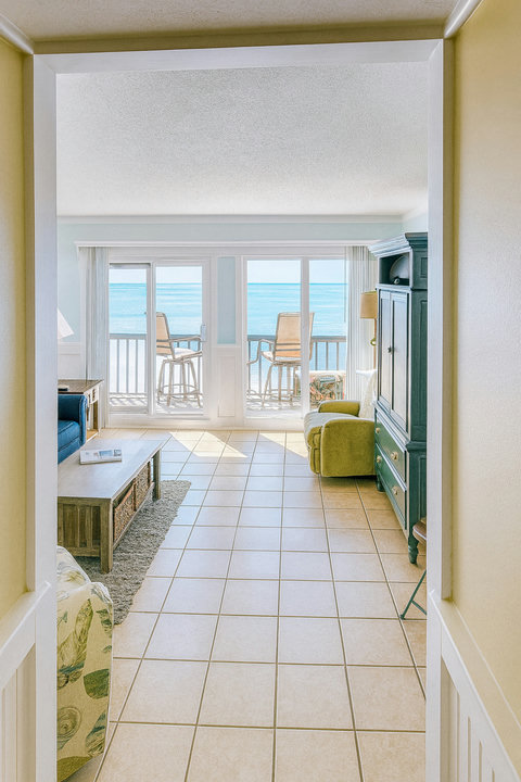 Living room opens to balcony and ocean horizon