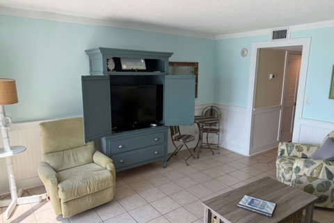 TV armoire, green recliner, and corner bistro set