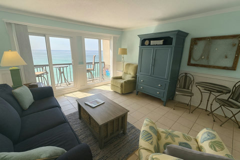 Living area with balcony doors to emerald Gulf