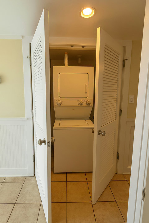 Stacked washer and dryer in louvered closet