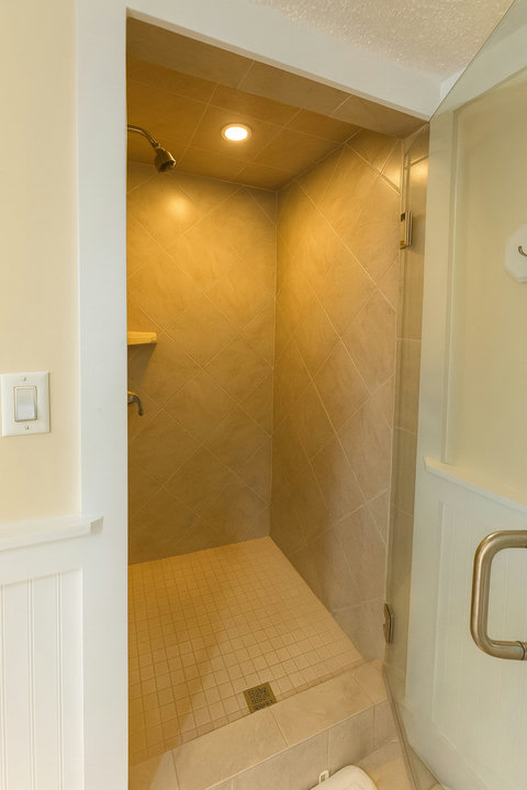 Diamond-tile walk-in shower with chrome fixtures