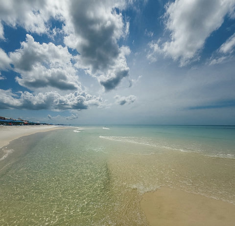 Sugar-white sand meets crystal emerald Gulf water