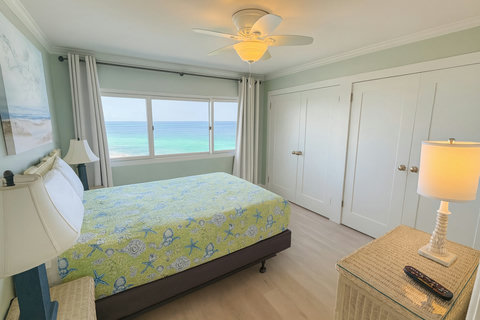 Bedroom window framing turquoise Gulf horizon