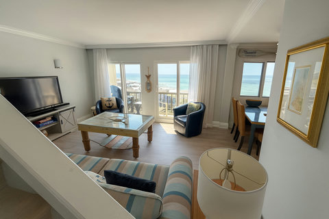 Living and dining with panoramic Gulf glass doors
