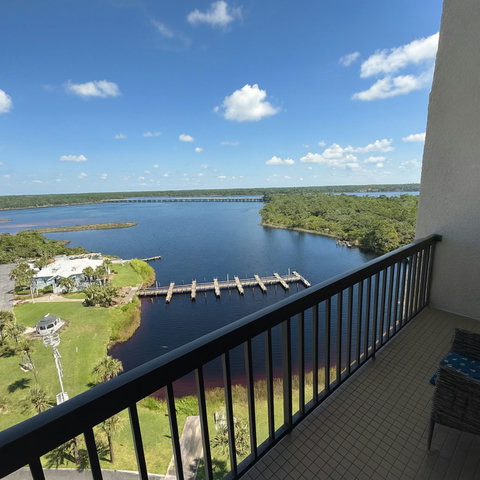 High balcony view of docks, lake, and palm lawns