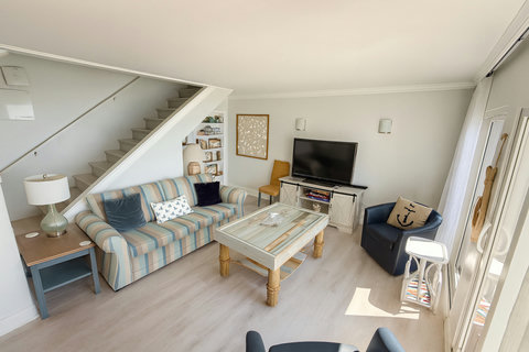 Striped sofa and rope coffee table in coastal lounge