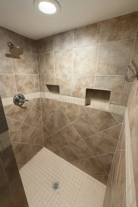 Walk-in shower with mosaic floor and rainfall head