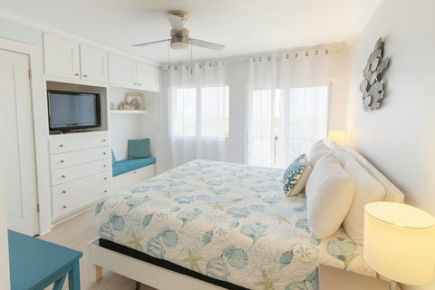Seashell bedroom with built-in TV and window seat