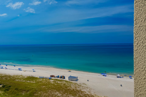 Elevated Gulf panorama with blue beach umbrellas