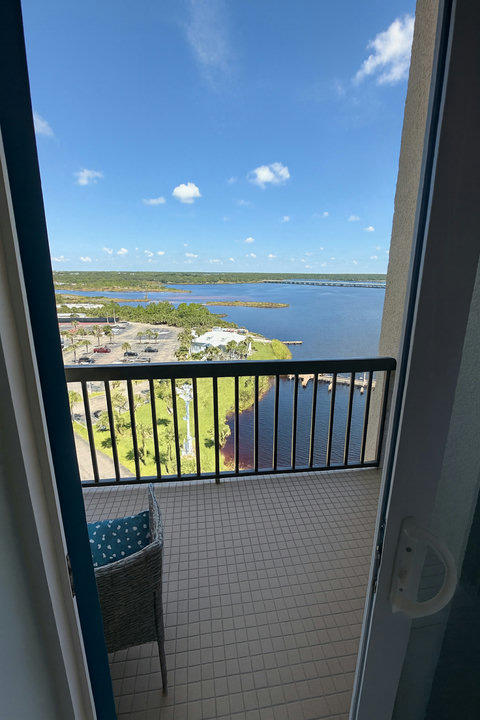 Private balcony chairs facing bay and distant bridge
