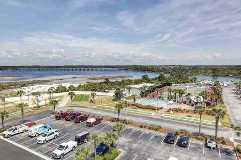 Pool, tennis, shuffleboard, and bay views from above