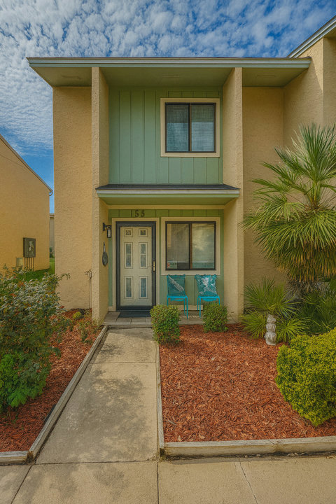 Welcoming entry with turquoise chairs and unit 153