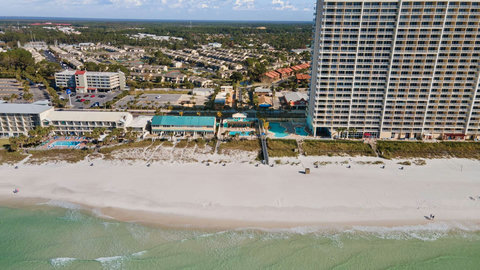 Aerial coastline with emerald Gulf and beachfront towers